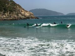 14C Surfers surf the waves at Big Wave Bay on Dragons Back hike Hong Kong
